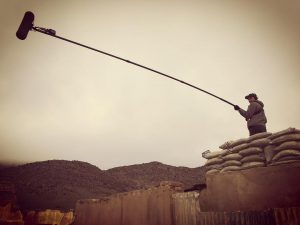 A boom pole on the OUR GIRL set