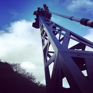 Director of photography Lance Gewer riding high on a Giraffe crane